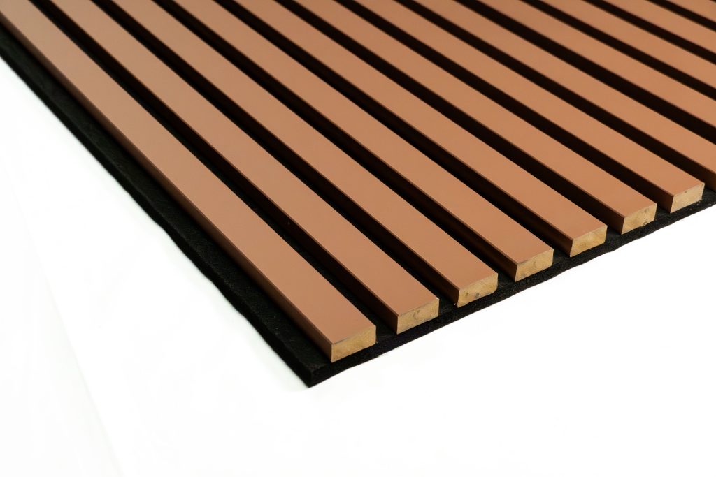 Close-up of a WoodUpp acoustic slat panel: evenly spaced, rectangular brown wood slats bonded to a black felt backing, showing the corner section and chamfered ends. The WoodUpp slatted acoustic board displays uniform gaps for sound absorption and a smooth painted finish.