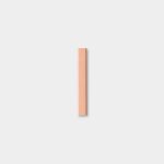 Minimalist photograph showing a single WoodUpp product: a slim, rectangular wood repair stick in a warm peach-beige tone with subtle grain, positioned vertically and centered on a soft light-gray background, casting a faint shadow to emphasize its smooth, square-edged form.