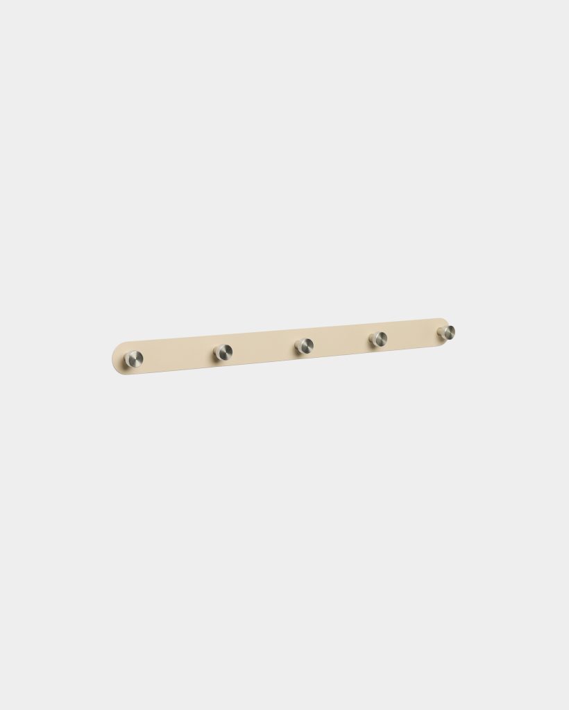 WoodUpp beige wall-mounted coat rack featuring a slim rounded-rectangle wooden backplate with five evenly spaced brushed stainless-steel cylindrical pegs. Minimalist modern design, matte sand-beige finish, and compact low-profile mounting suitable for coats, bags or towels in hallway, entryway or bathroom.